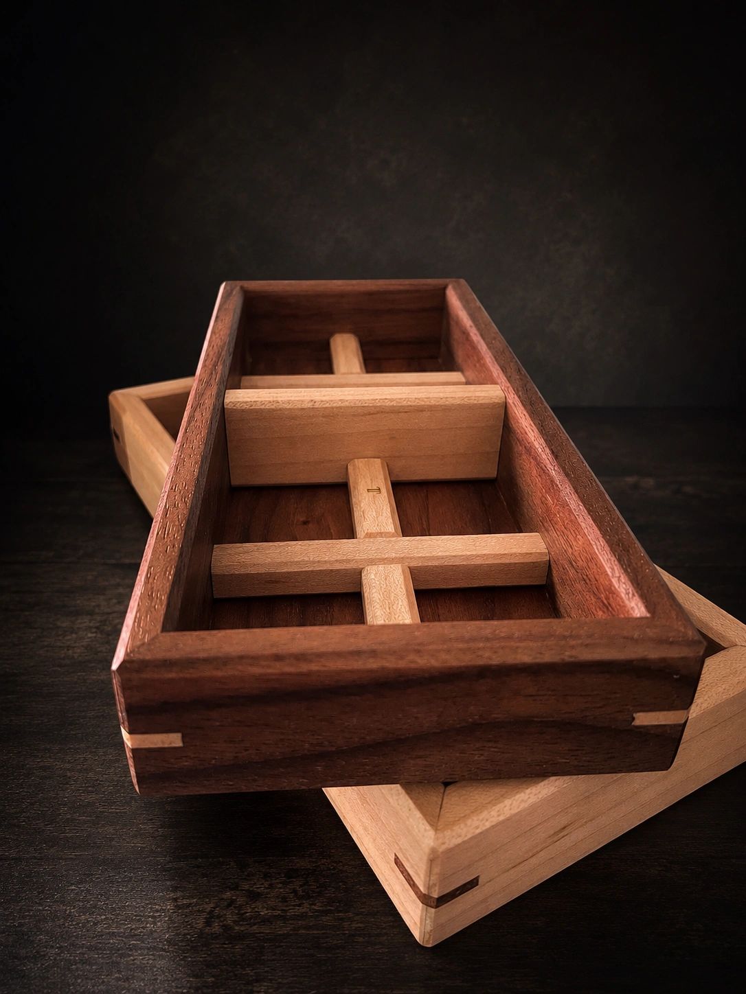 Two handcrafted wooden boxes with sliding mechanisms.