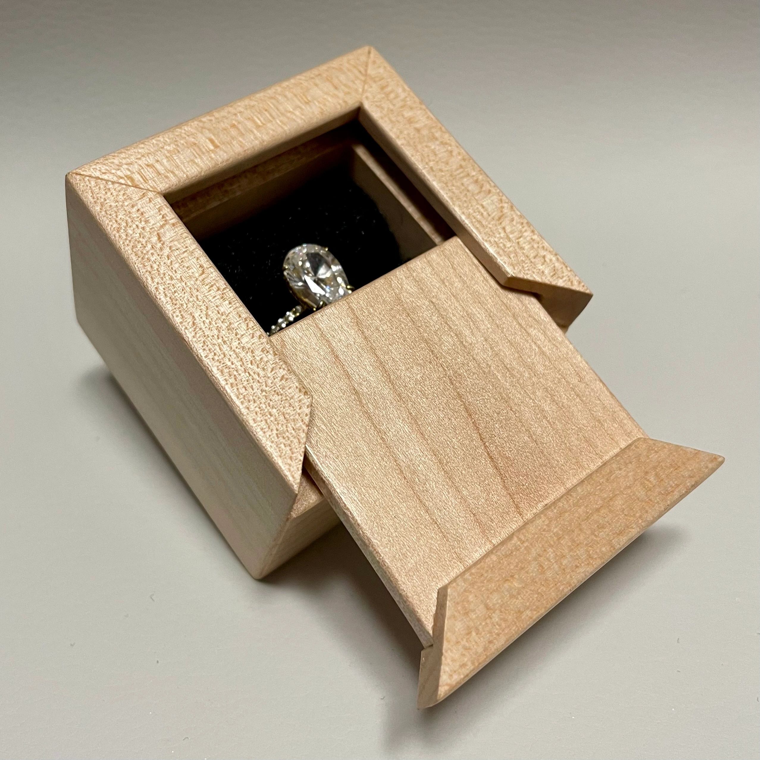 Diamond ring in a wooden box.