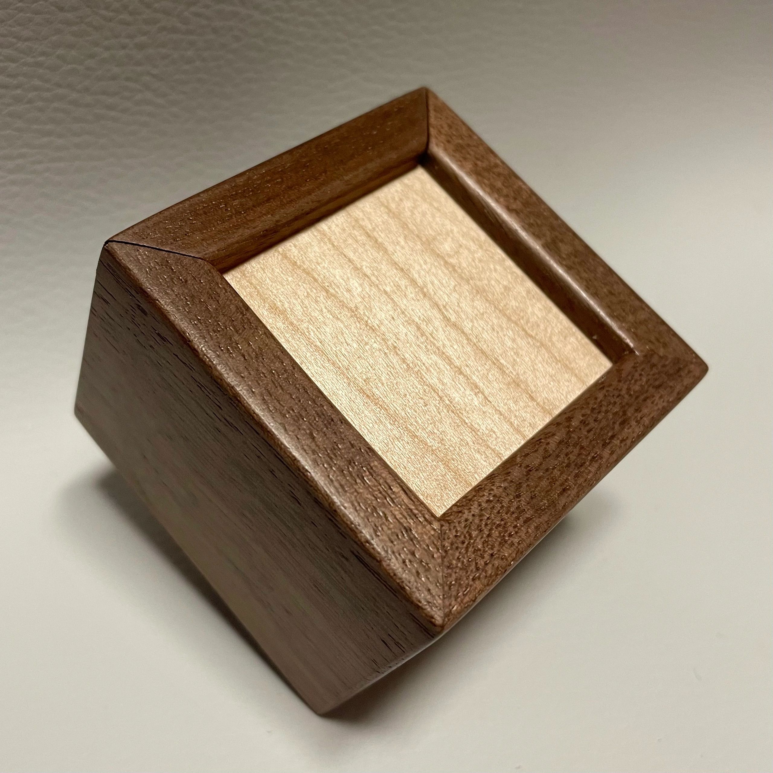 Close-up of a wooden box corner with contrasting wood tones.