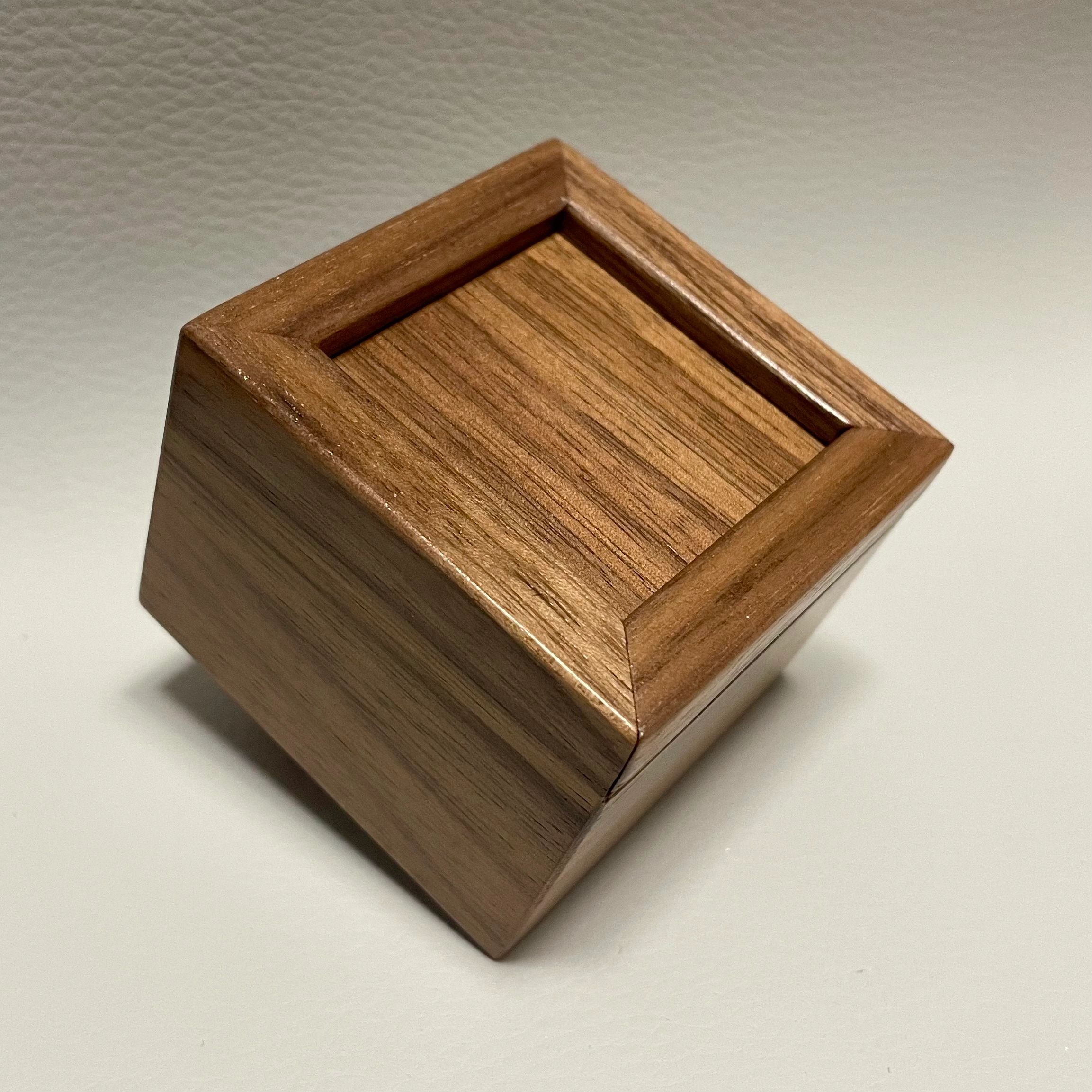 Wooden block with a recessed top surface.