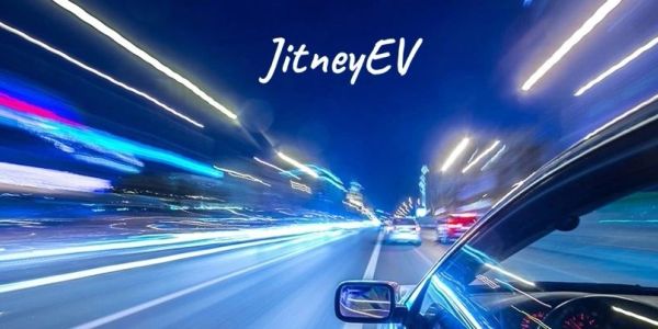 Night drive with light trails and JitneyEV logo.