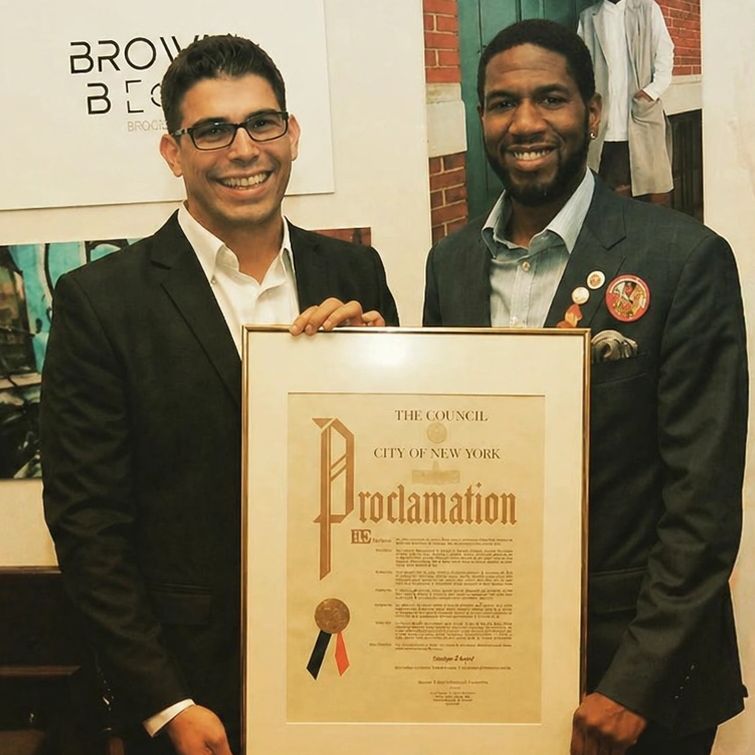 Stefan Ringel and former Council Member Jumaane Williams holding a City Council proclamation.