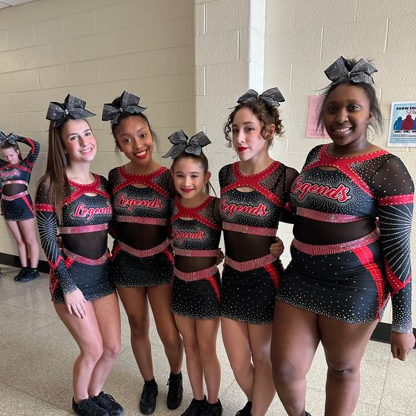 Cheerleading team posing together in matching outfits.