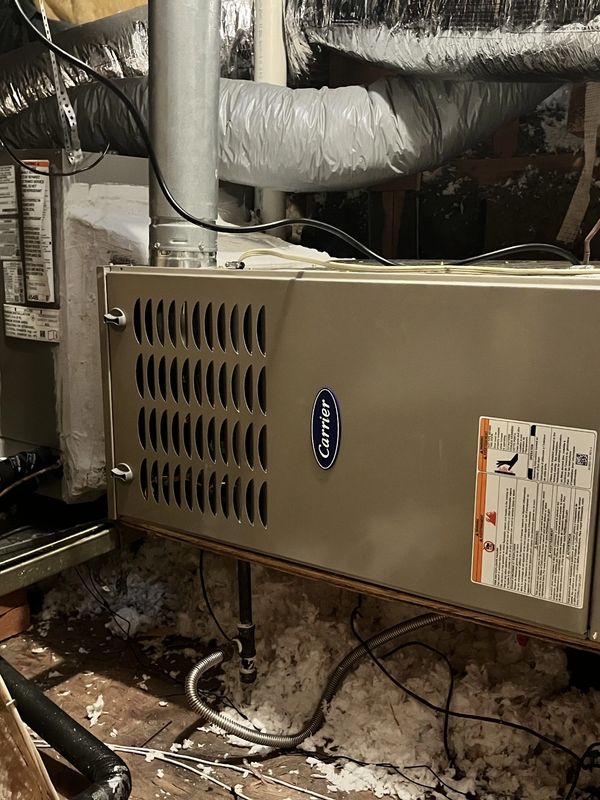 A Carrier HVAC unit installed in a basement.