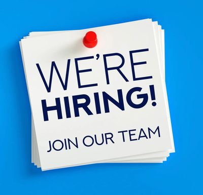 Stack of notes with 'We're Hiring! Join Our Team' pinned on a blue background.