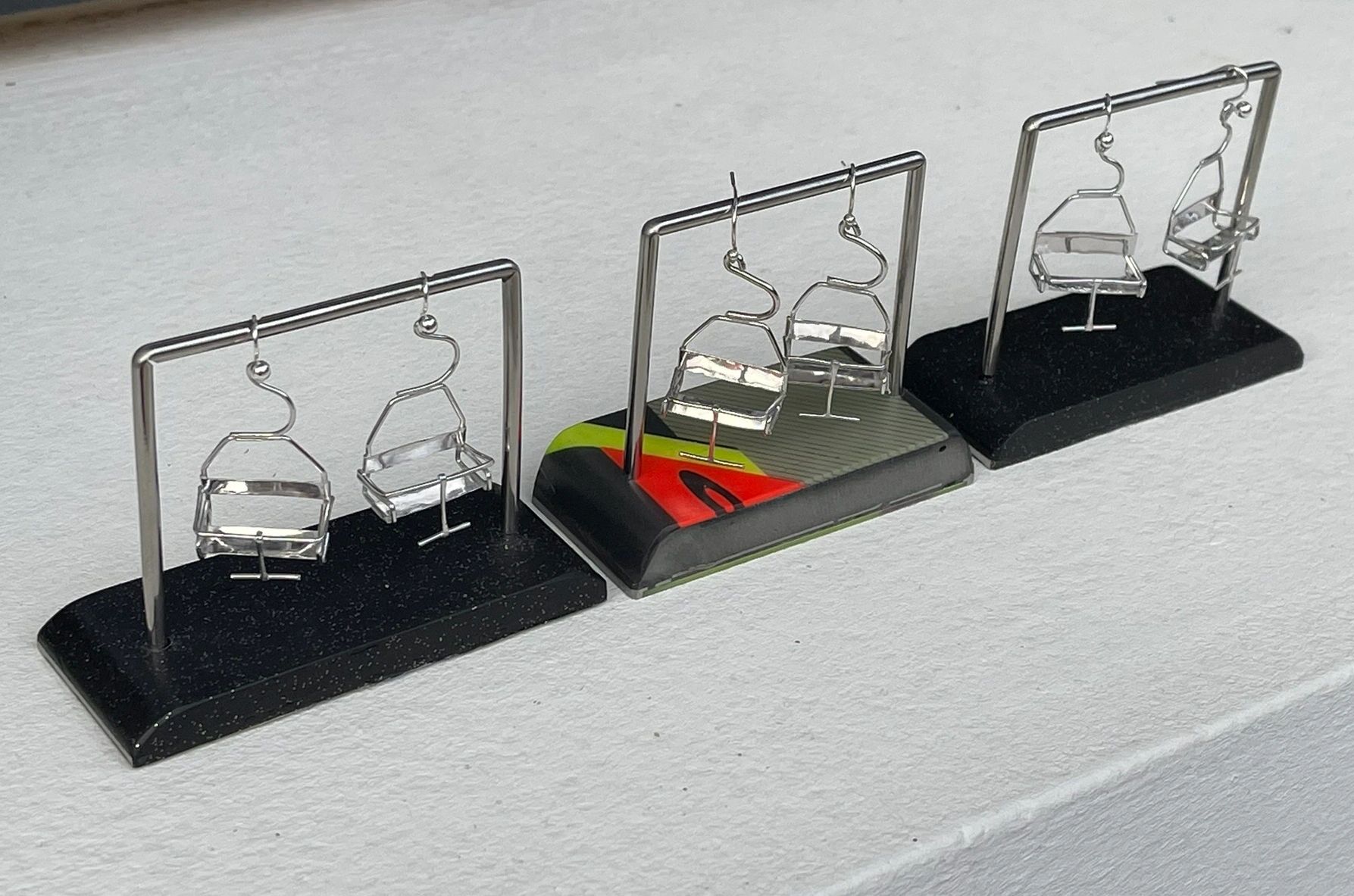 Miniature chairlifts made in copper or brass then rhodium plated. 