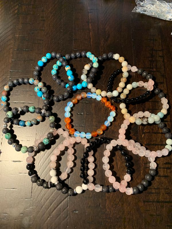 Colorful beaded bracelets arranged on a wooden surface.