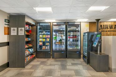 Hotel convenience area with snacks and beverages in refrigerators.