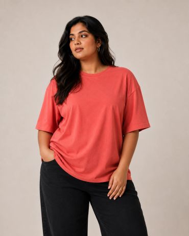 Woman in a red t-shirt and black pants.