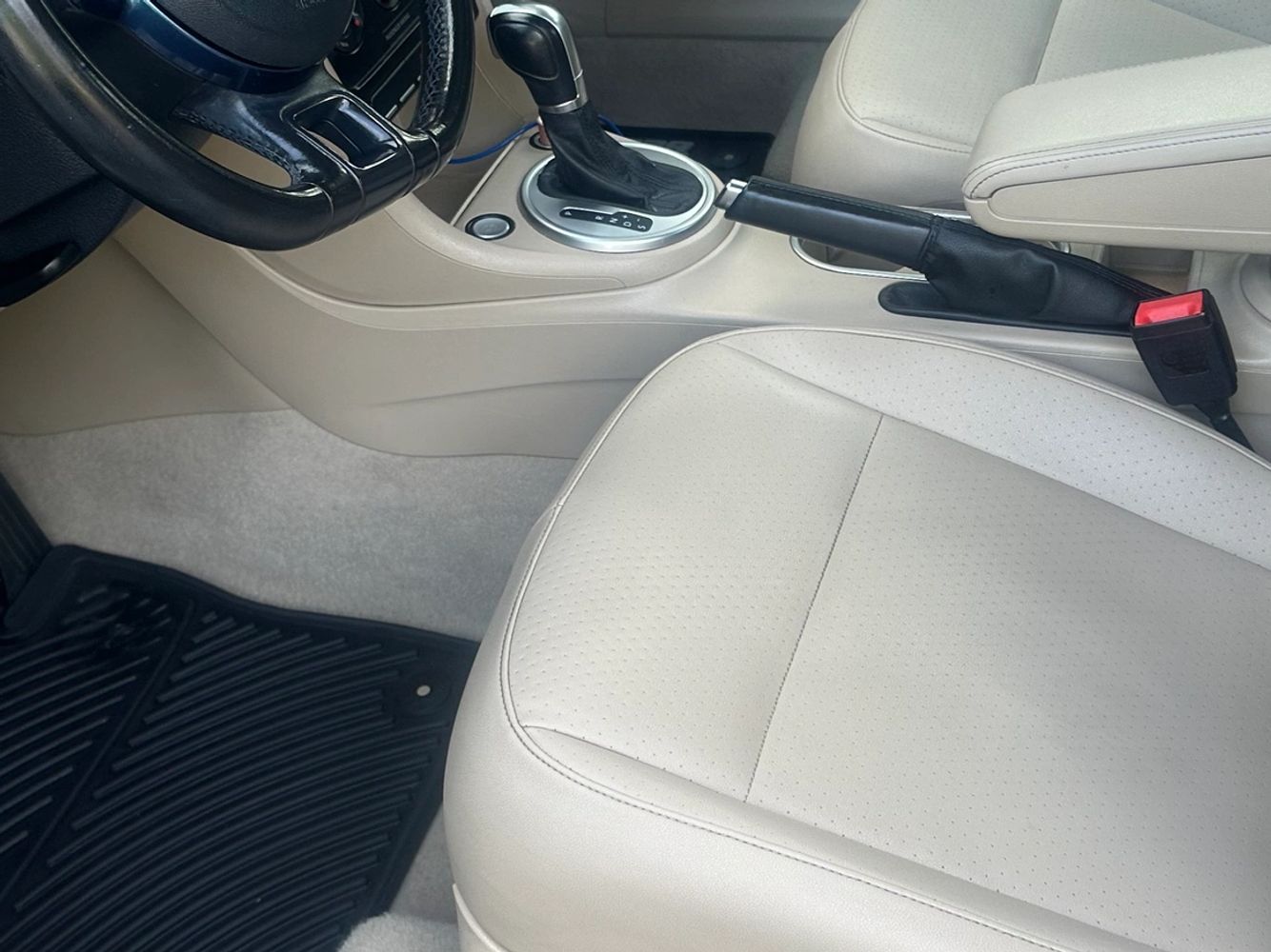 Clean beige interior of a Volkswagen car with blue dashboard accents.
