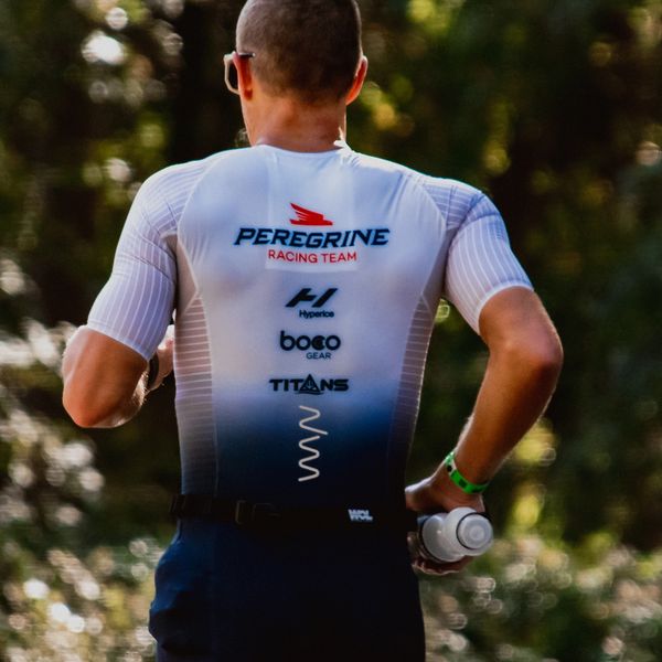Image of runner in white jersey and blue shorts.