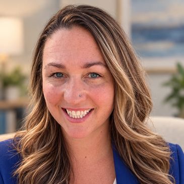 Smiling woman with wavy hair and blue blazer.