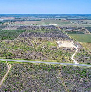 10 acres of land for sale near San Antonio with fencing, power, water, culvert, and driveway.