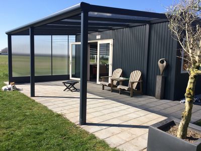 Veranda with chairs under it 