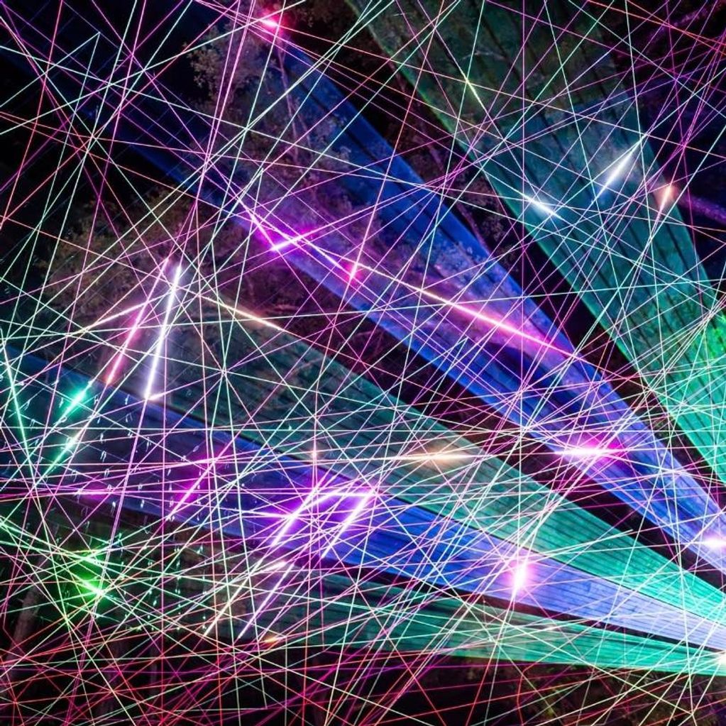 Custom laser art installation creating colorful atmospheric beams and visual effects.