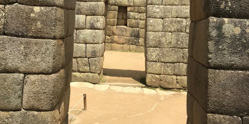 Ancient stone doorway and walls at a historic site.