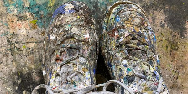 A man wearing shoes working painting