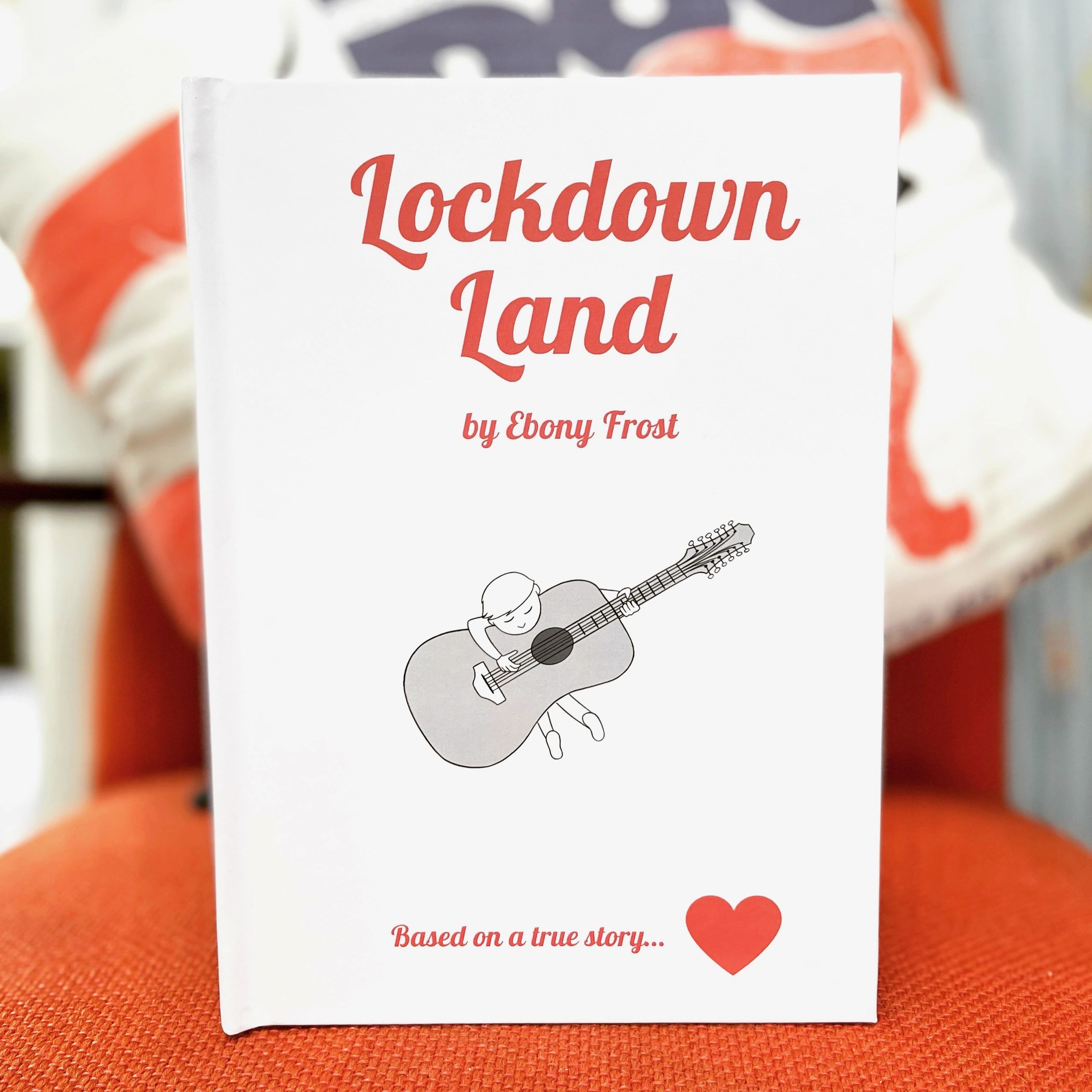 Book cover titled 'Lockdown Land' by Ebony Frost with a guitar illustration.