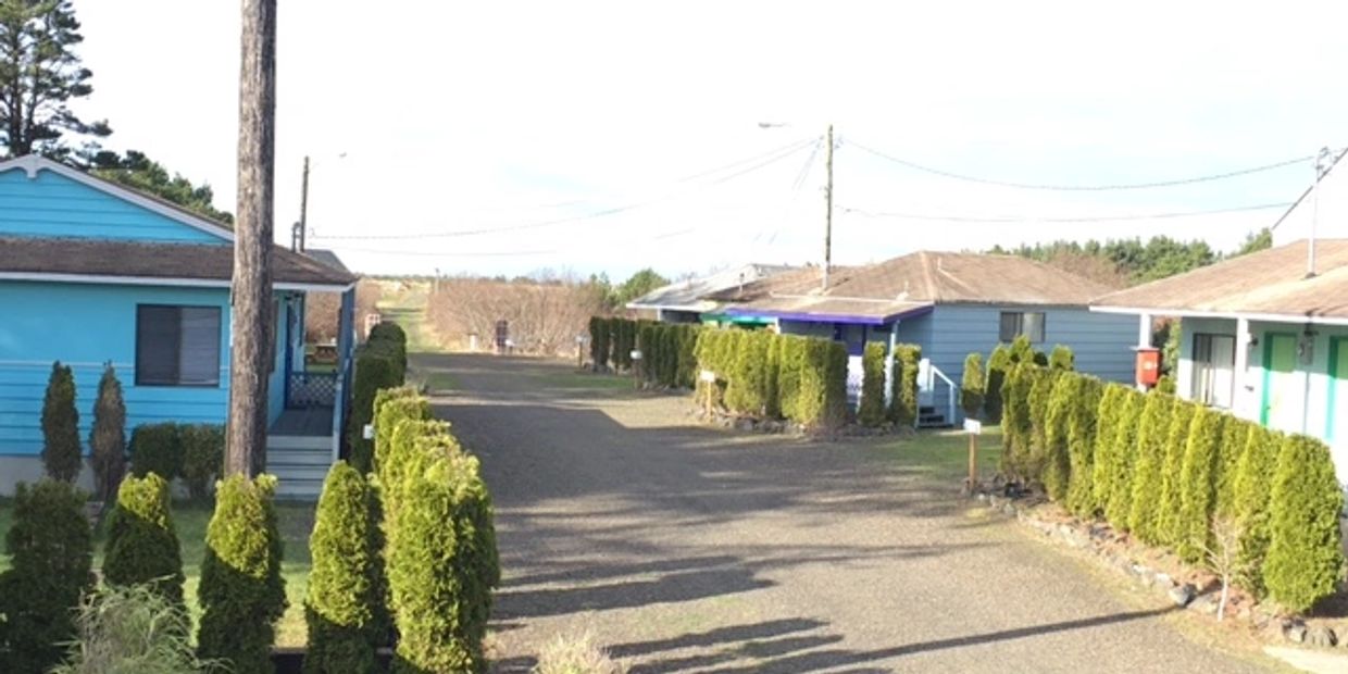 Row of Blue Houses Sitting Next to Each Other