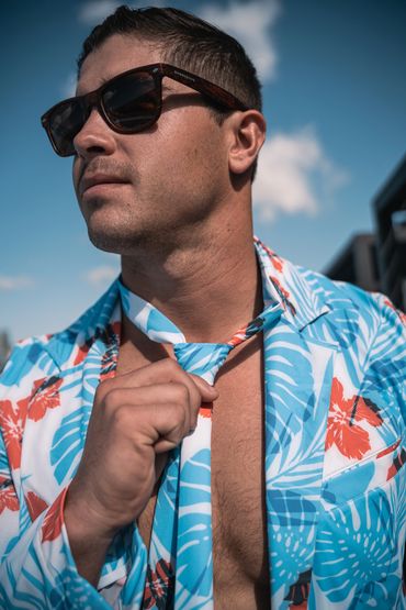 man grabbing his hawaiian swim suit tie 