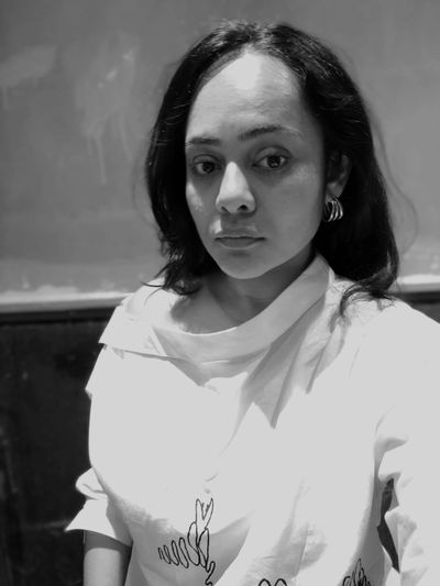 Black and white portrait of a woman with a serious expression.