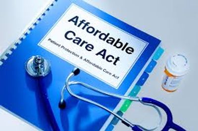 A blue binder titled Affordable Care Act with a stethoscope and prescription bottle.