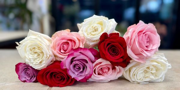 Bouquet of multicolored roses on a table.
