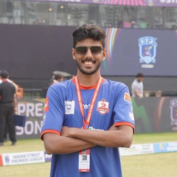 Young man in sportswear smiling at Indian Street Premier League stadium.