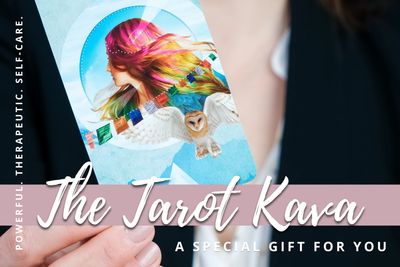Person holding a colorful tarot card with an owl and rainbow-haired figure.