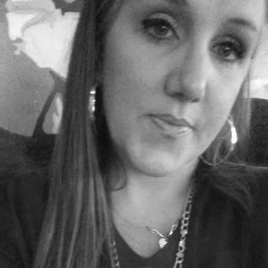 Black and white close-up portrait of a woman with long hair and hoop earrings.