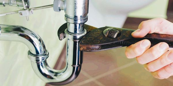 Tighten pipe fitting under bathroom sink