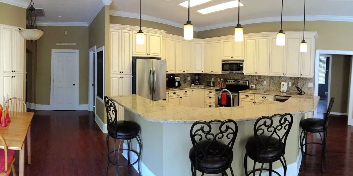 Newly remodeled kitchen in Tampa with granite countertops and pendant lighting
