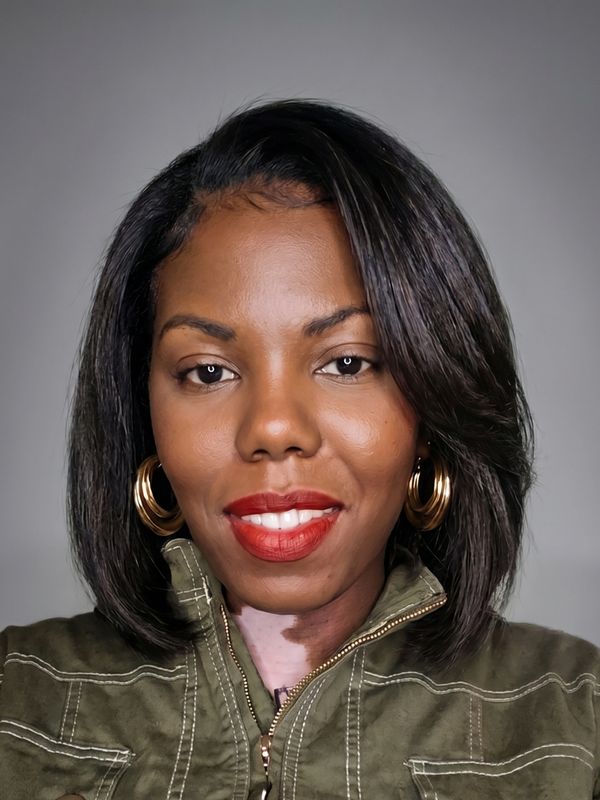 Smiling woman with red lipstick and gold hoop earrings.