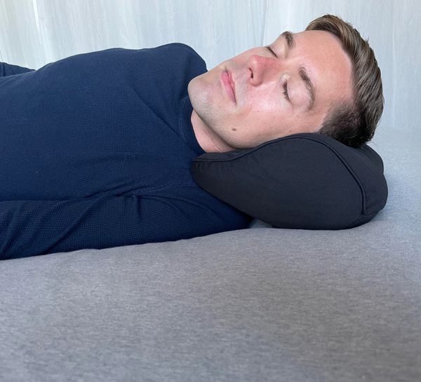 Man using the Arto Pillow - Memory Foam  while laying in bed.