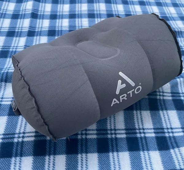 The Arto Pillow - Inflatable sitting on a picnic blanket. 