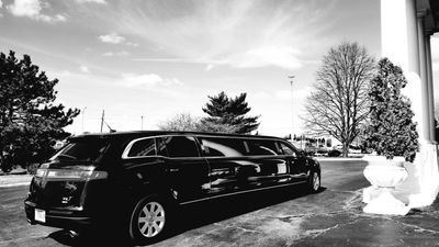 A black-and-white photo of a limousine