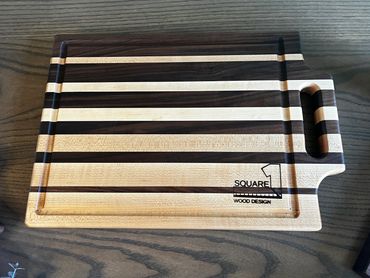 Cutting board with handle and juice groove.