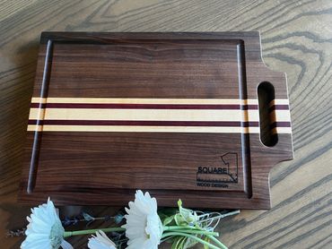 Cutting board with handle and juice groove.