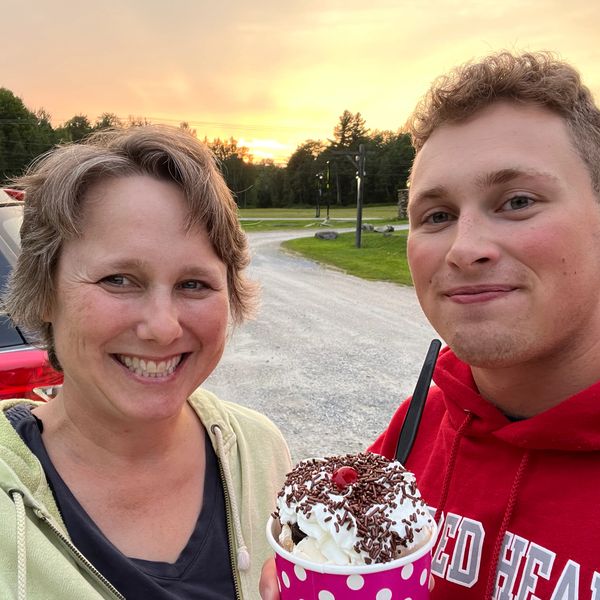 A photograph of a woman and a teenage boy with an ice cream sundae.