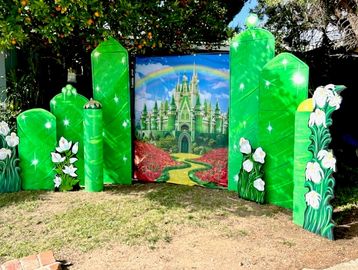 Display of green structures and a castle backdrop.