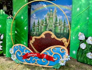A colorful photo booth frame with a fairy tale castle backdrop.