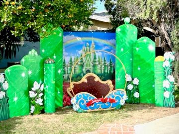 Festive St. Patrick's Day themed outdoor decoration with rainbow and castle.