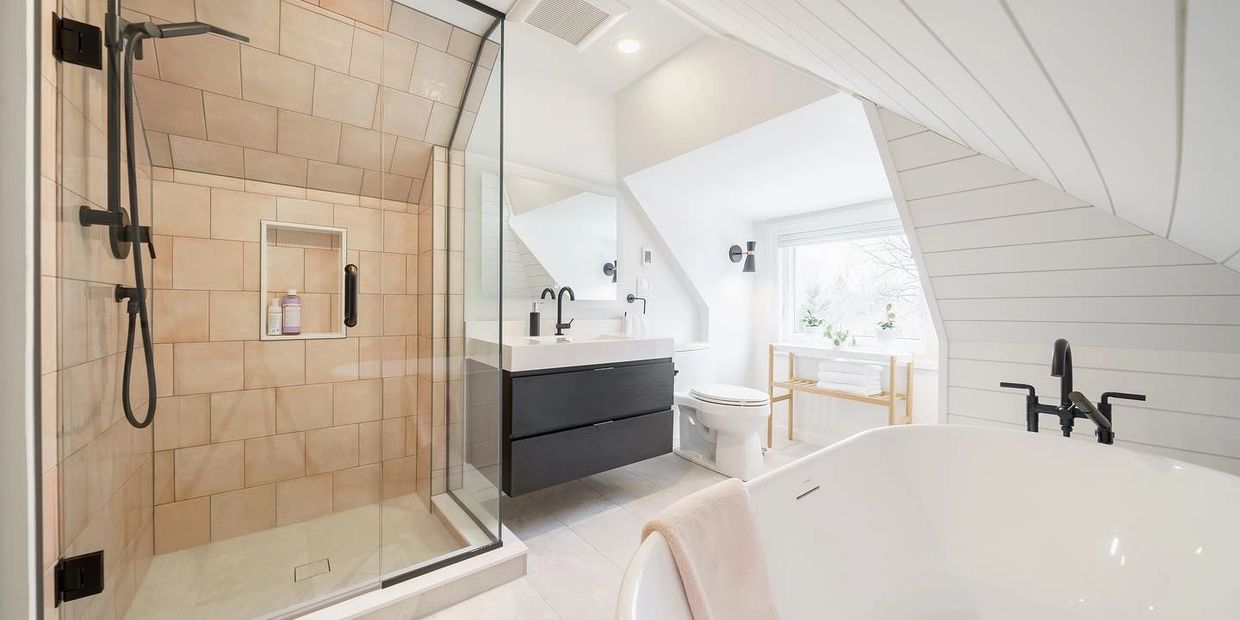 Modern bathroom with glass shower, freestanding tub, and black fixtures.
Hamilton bathroom Remodel.