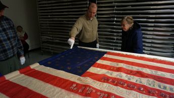 Matt VanAcker showing our group the National Colors of the 12th Michigan Volunteer Infantry. 