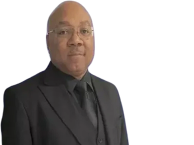 A man in a black suit and glasses.