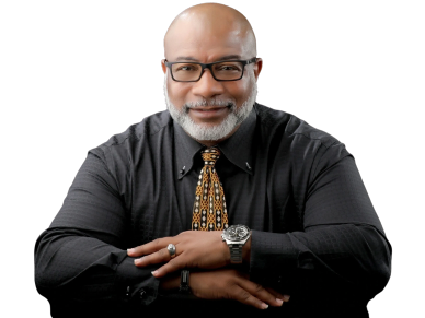 Smiling man in glasses wearing a patterned tie and watch.