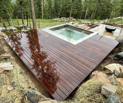 Custom mountain deck built around hot tub in Evergreen, Colorado by Global Cooperation LLC