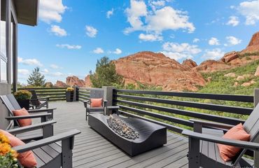 Composite deck with steel railings and fireplace on highlands ranch Colorado, best Deck Builder 