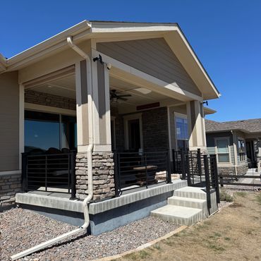 Horizontal steel railings with covered patio in Aurora, Co installed by Global Cooperation LLC