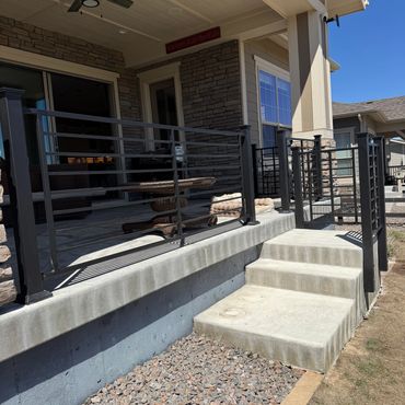 Horizontal steel railings with covered patio in Aurora, Co installed by Global Cooperation LLC